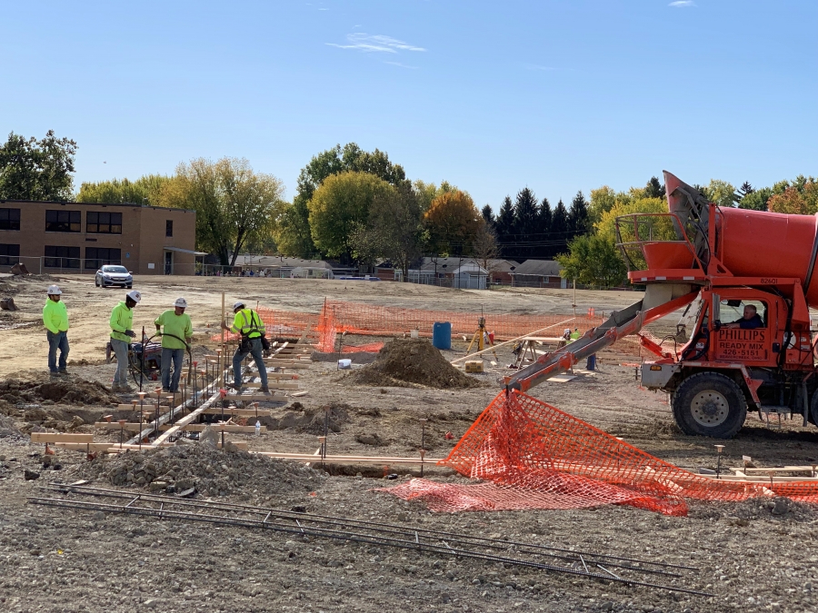 concrete truck and men at a construction site